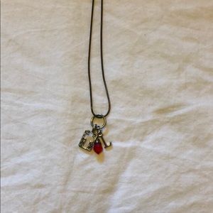 L cross red gem necklace